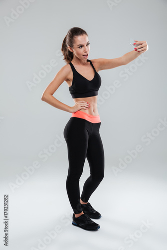 Full length picture of pretty fitness woman posing
