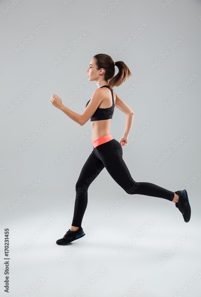 Full length picture of a sports woman running in studio Full length picture of a sports woman running in studio