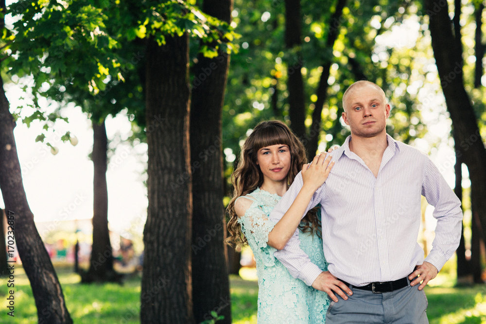Beautiful young couple on the park background Beautiful young couple on the park background