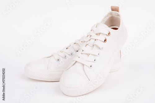Pair of new white sneakers, isolated on white background