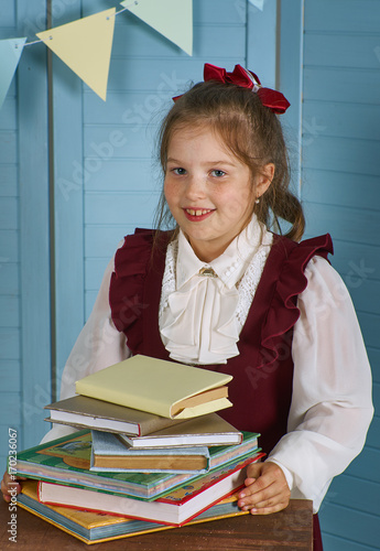 Happy little girl  with books photo