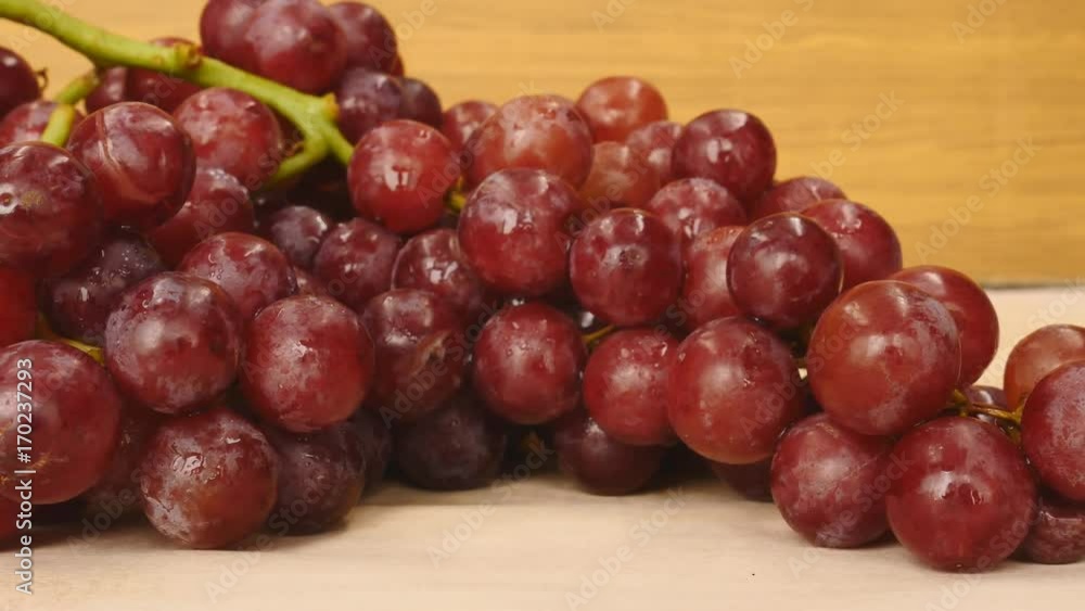 Panning - Red grapes on the wooden table. Panning - Red grapes on the wooden table.