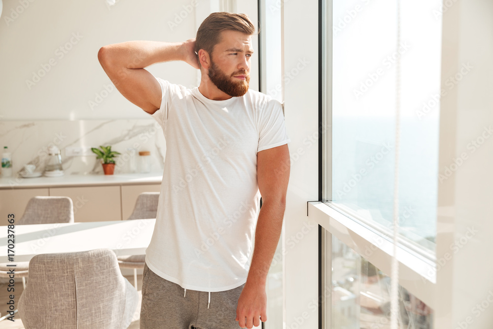 Cool bearded man posing near the window Cool bearded man posing near the window