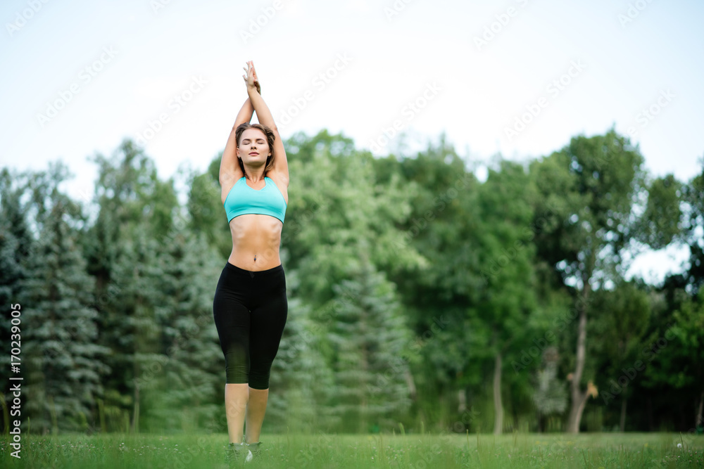 Fitness sport beauty girl doing yoga, fitness and stretching exercise in the park, outdoor sports Fitness sport beauty girl doing yoga, fitness and stretching exercise in the park, outdoor sports