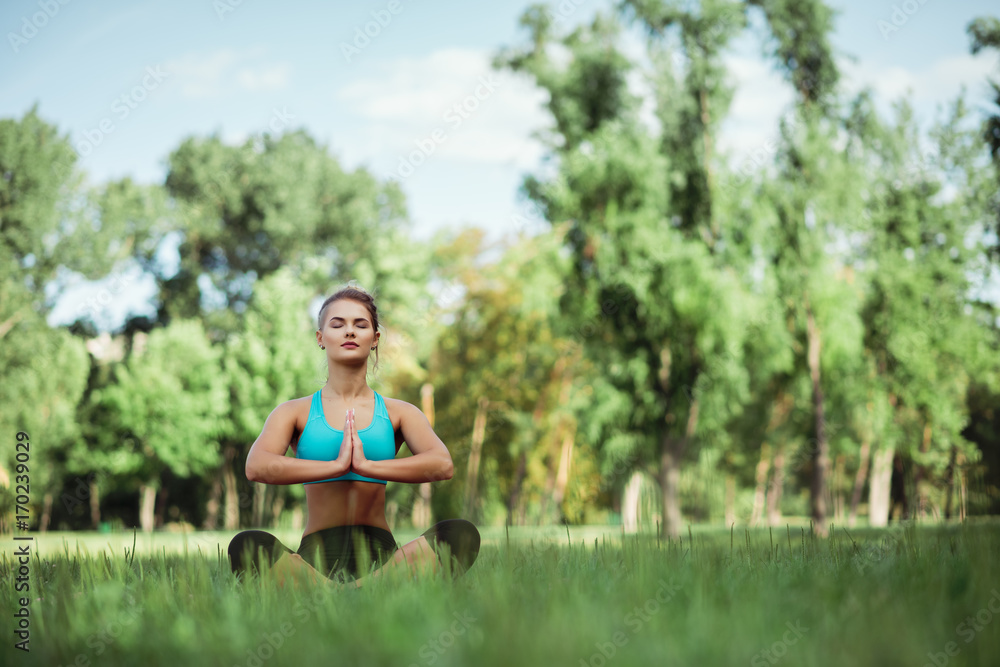 Fototapeta premium Fitness sport beauty girl doing yoga, fitness and stretching exercise in the park, outdoor sports