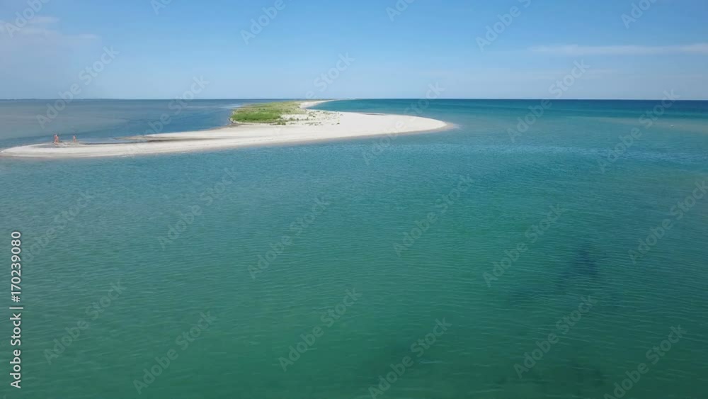 Impressive aerial shot of a splendid small island on a shoal of the Black Sea on a sunny day in summer. The skyscape and seascape look gorgeous and great Impressive aerial shot of a splendid small island on a shoal of the Black Sea on a sunny day in summer. The skyscape and seascape look gorgeous and great