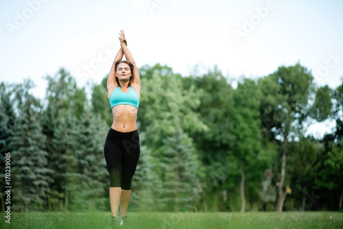Fitness sport beauty girl doing yoga, fitness and stretching exercise in the park, outdoor sports