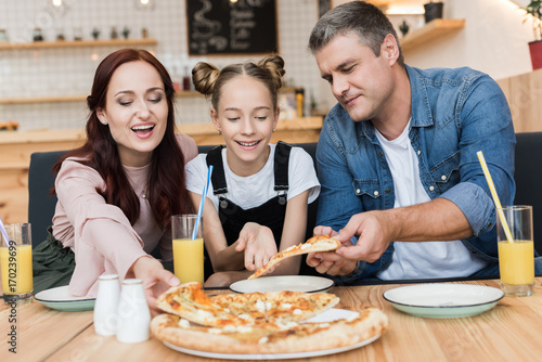 happy family eating pizza