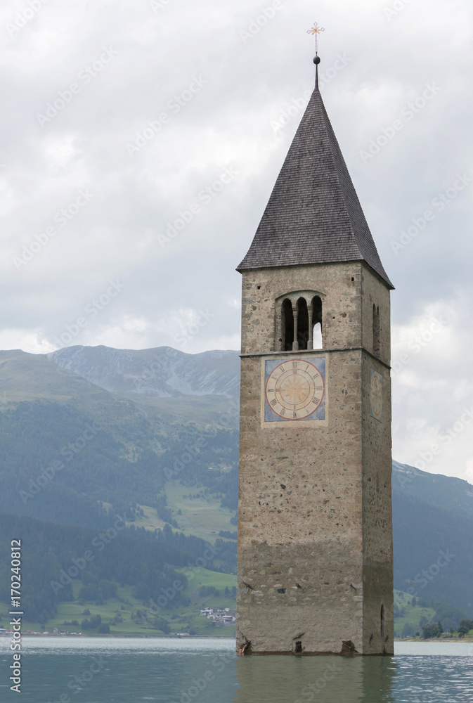Submerged tower of reschensee church deep in Resias Lake in Trentino-Alto valley
