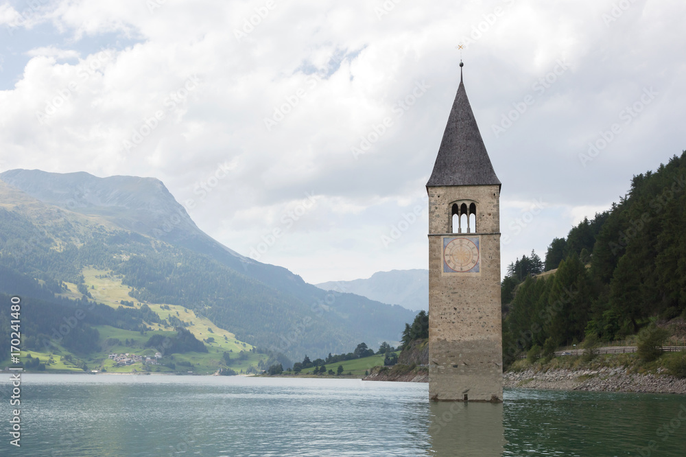 Submerged tower of reschensee church deep in Resias Lake in Trentino-Alto valley