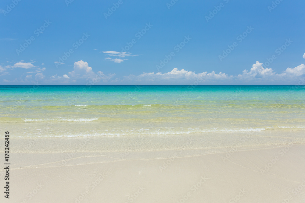 Tropical white sand beach with turquoise water under blue sky. Paradise background