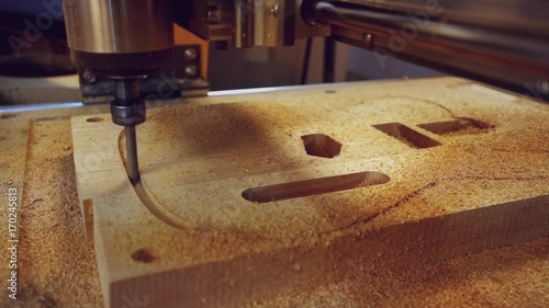 Manufacture of guitars. Milling a guitar deck on a machine with numeric control programs. photo