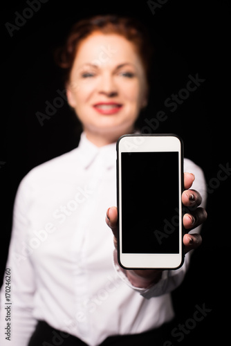 Woman showing smartphone screen