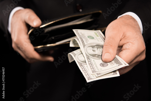 Male hands taking money from wallet