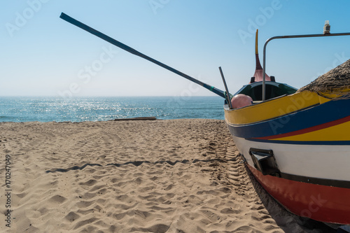 Arte Xavega typical portuguese old fishing boat on the beach in Paramos, Espinho, Portugal. photo