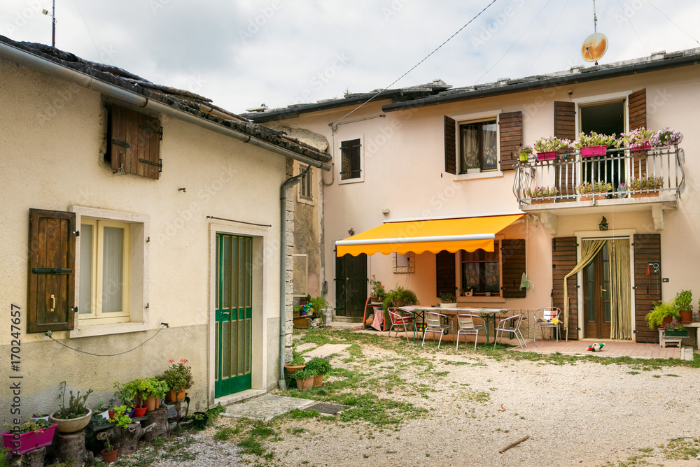 Cescatto, Italy - August 22, 2017: House with patio from the mountain village of Italy. Cescatto, Italy - August 22, 2017: House with patio from the mountain village of Italy.