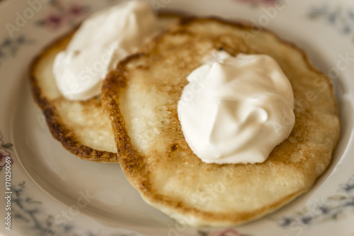 two pancakes with sour cream