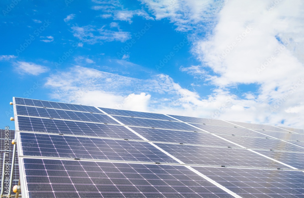 Solar power panels for innovation green energy for life with mountains and blue sky background. Solar power panels for innovation green energy for life with mountains and blue sky background.