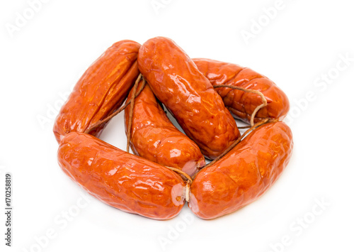 A bunch of meat sausages isolated on white background close up