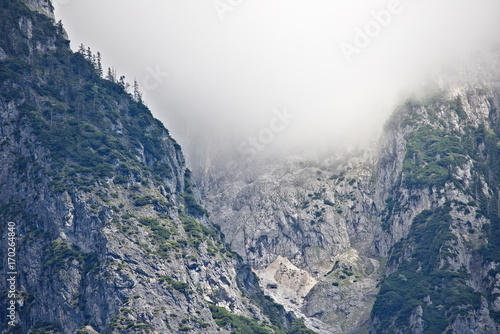 Rocky slope of a mountain partly covered by mist in the Tennen range in the Austrian Alps near the town of Werfen © Harald
