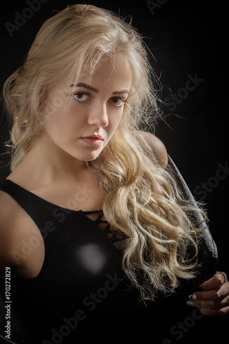 beautiful young blond female portrait on black background