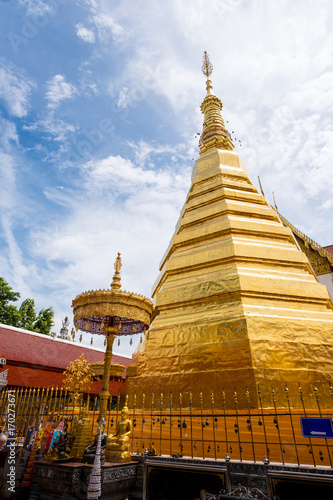 Golden Pagoda from  -The royal temple- Wat Phra That Cho Hae  Phrae  Thailand with blue sky