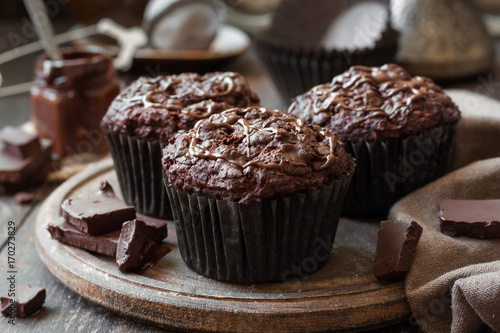 chocolate muffins on a wooden background