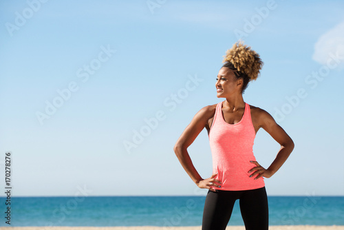 fit woman standing by the beach