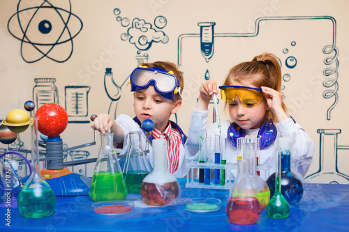 small children do chemical experiments. cheerful science,
