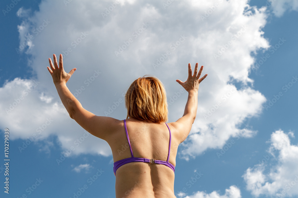 Illusion of how a young woman holds a cloud