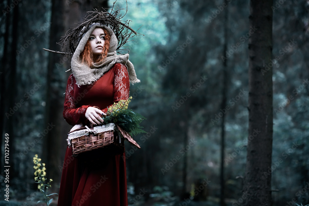 Red-haired witch in a dense forest
