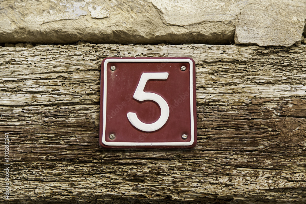Number five of information on the wall of a house Number five of information on the wall of a house