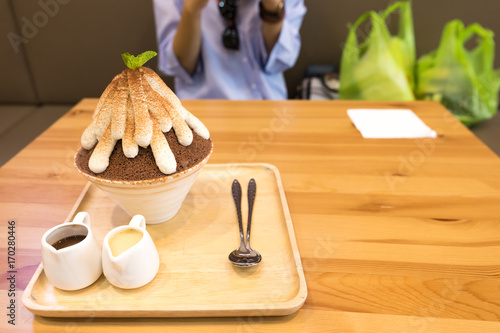 Chocolate Korean Shave Ice Patbingsu or Bingsu Frozen dessert with woman after shopping