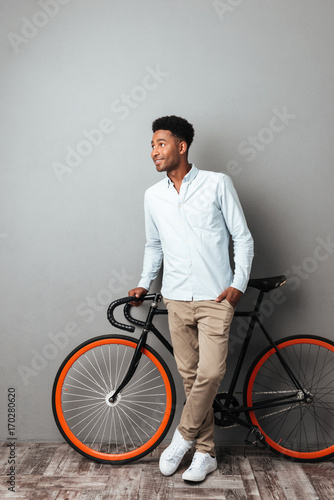 Man standing near bicycle isolated