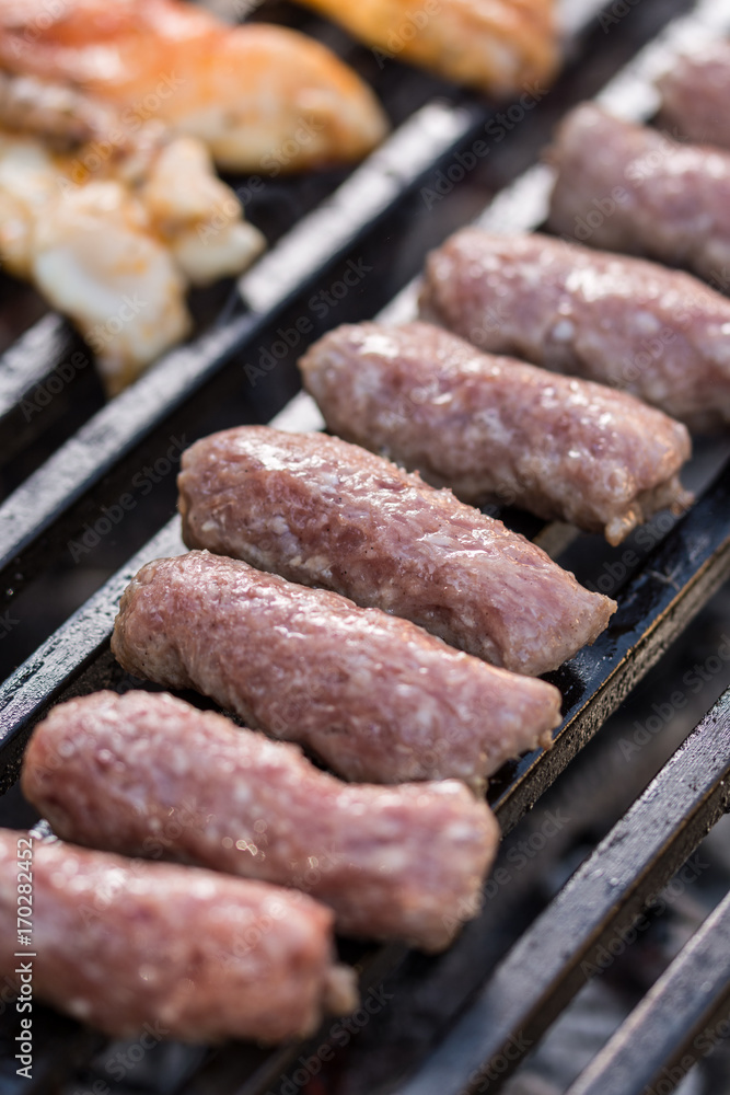 Selective focus on minced meat kebabs on the barbecue grill