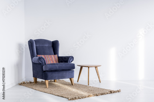 Garnet armchair on brown carpet