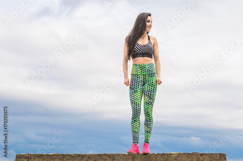  The girl the brunette plays sports on the seashore - on the beach. photo