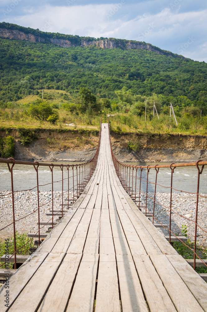 Suspension cable bridge, Crossing the river. Adygea republic, Krasnodar region, Russia