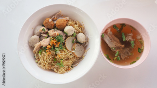 Egg noodle dry Asian food with bone soup top view