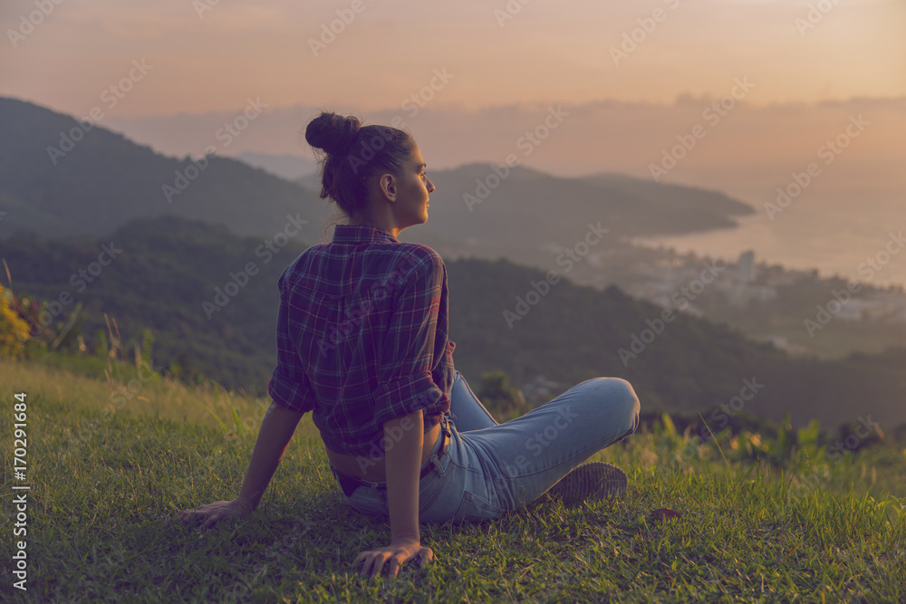 Hipster young girl with backpack enjoying sunset on peak mountain. Tourist traveler on background valley landscape view mockup. Toned. Instagram filter