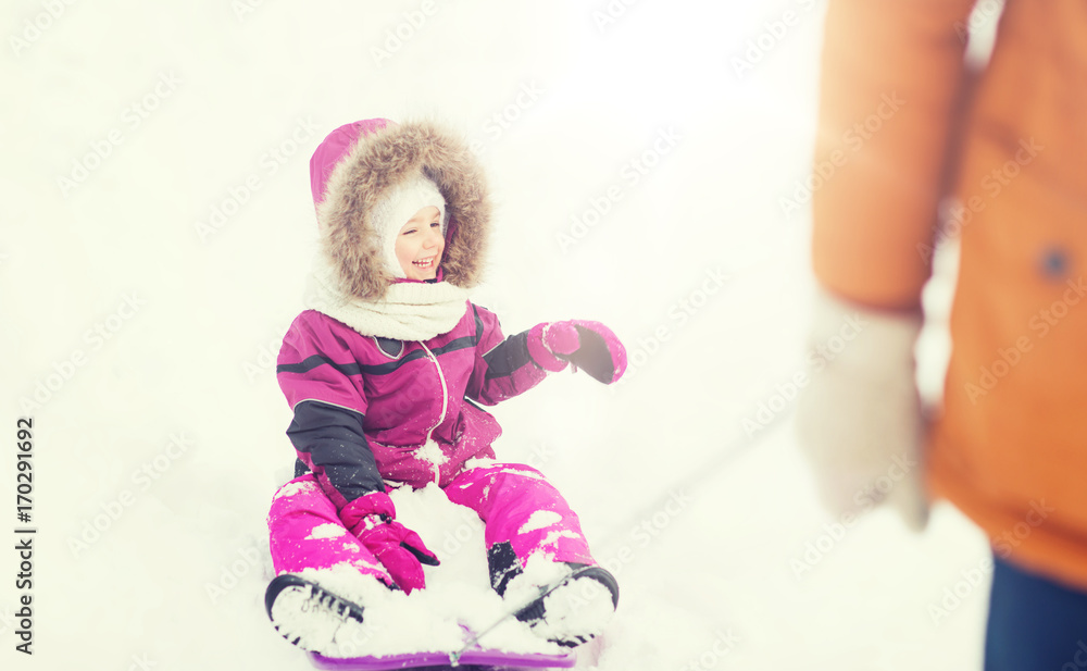 happy little kid on sled outdoors in winter happy little kid on sled outdoors in winter