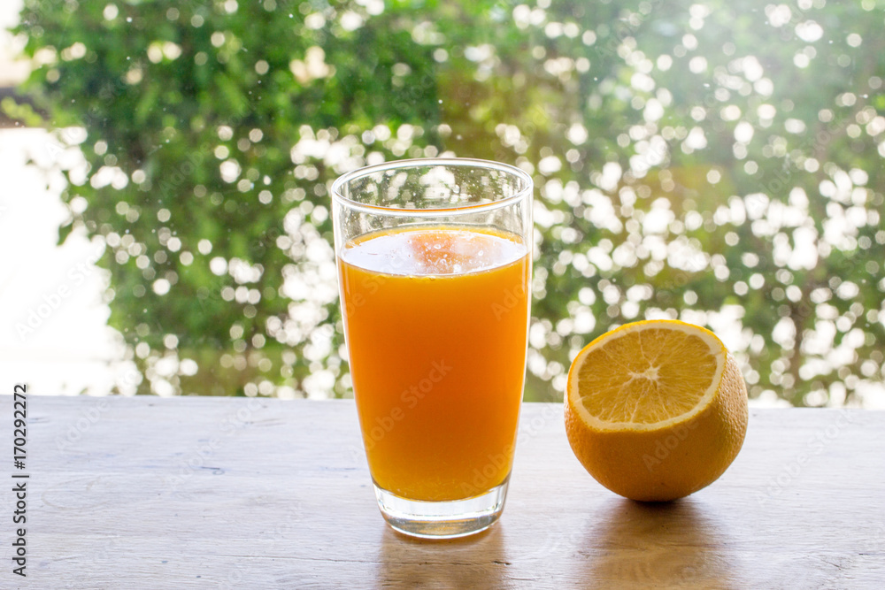 Pouring orange juice into glass.