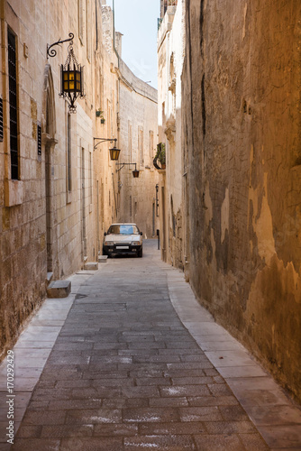 Narrow medieval street with stone houses in Mdina, Malta