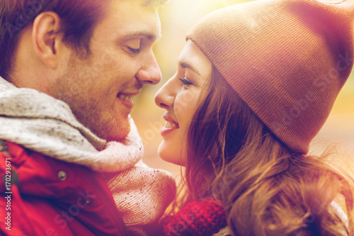 close up of happy young couple kissing outdoors photo