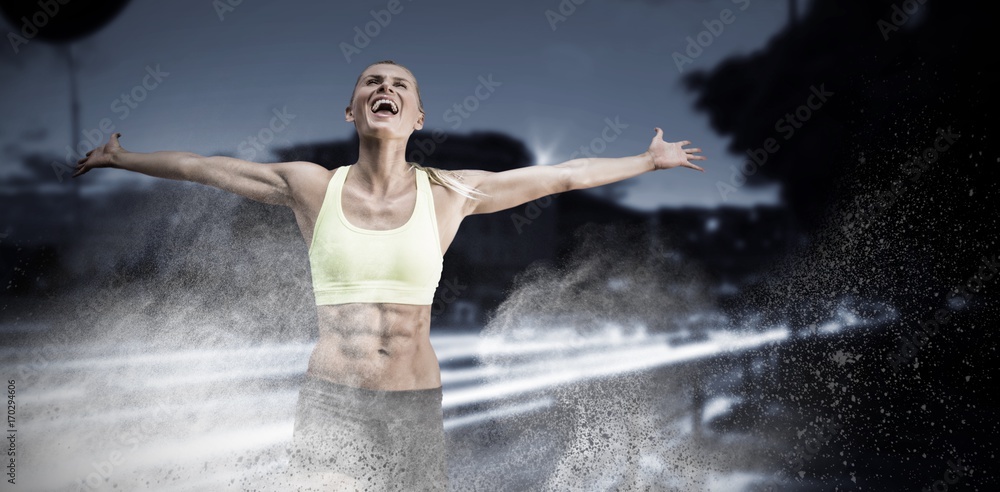Composite image of fit woman celebrating victory with arms