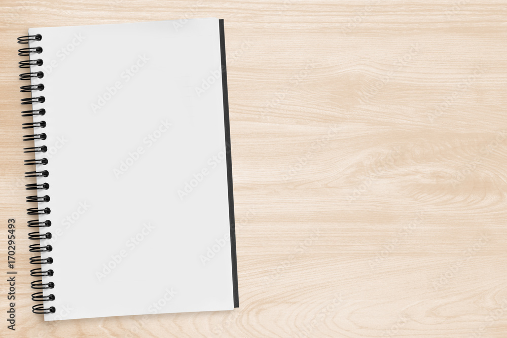 Blank notebook page is on top of wood office desk table. Top view with copy space, flat lay. Blank notebook page is on top of wood office desk table. Top view with copy space, flat lay.