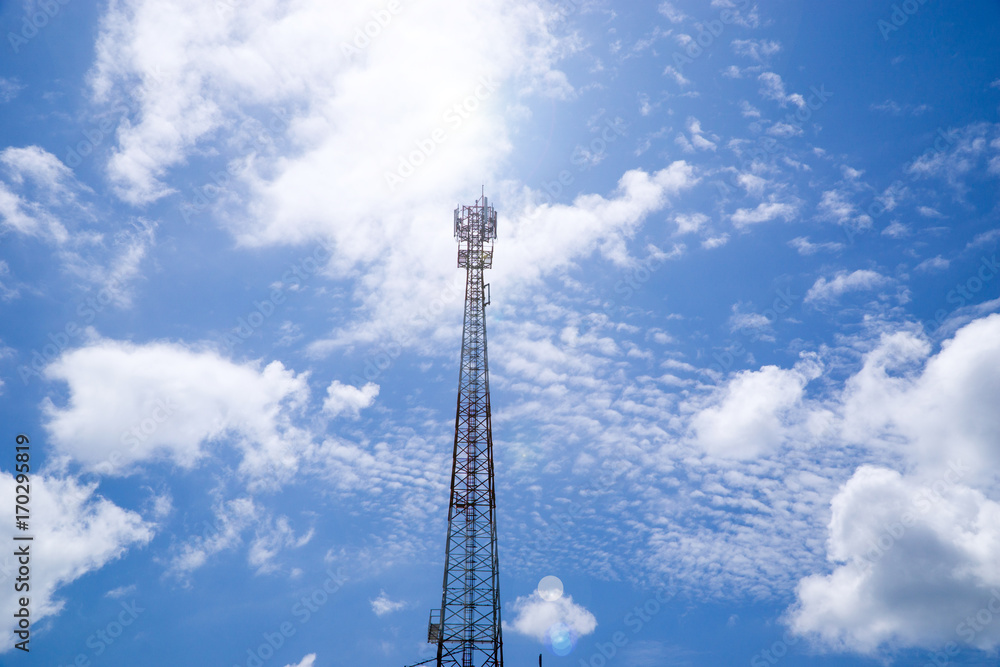 Mobile phone and communications tower with cloud and blue sky. Mobile phone and communications tower with cloud and blue sky.