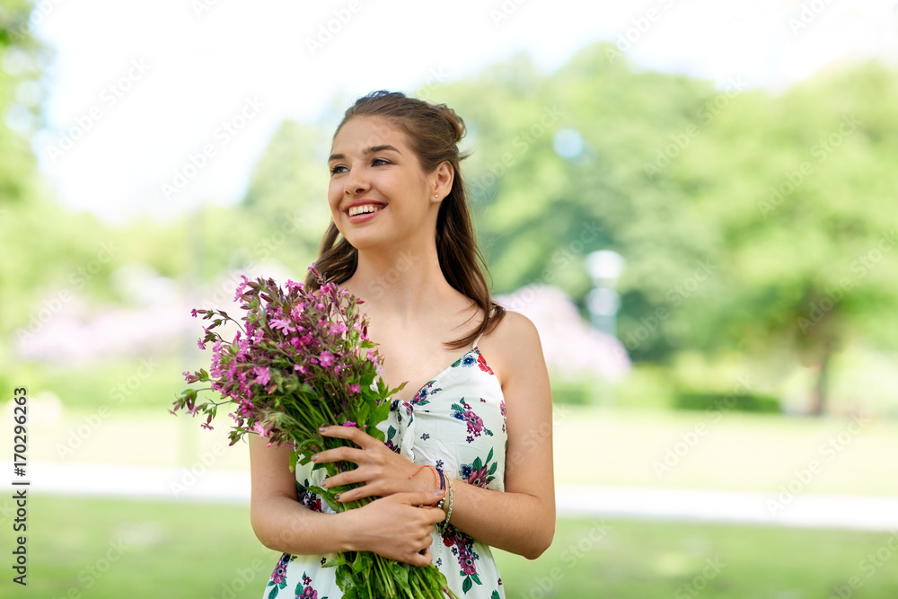happy young woman with flowers in summer park happy young woman with flowers in summer park