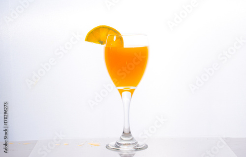 Orange juice splashing out of glass., Isolated white background.