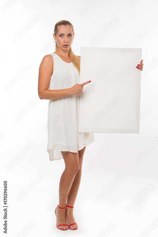 Young fearful woman portrait of a confident businesswoman showing presentation, pointing placard gray background. Ideal for banners, registration forms, presentation, landings, presenting concept. Young fearful woman portrait of a confident businesswoman showing presentation, pointing placard gray background. Ideal for banners, registration forms, presentation, landings, presenting concept.